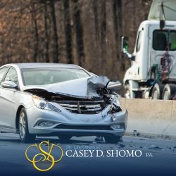 After a car accident in Palm Beach Gardens, an empty vehicle with a smashed front end sits on the highway