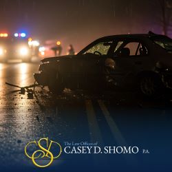 After a Palm Beach Gardens car accident at nighttime, a damaged vehicle siting in the road