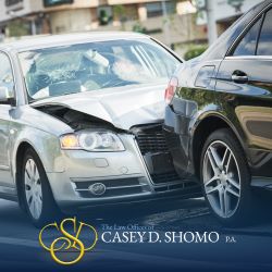 A silver car slams into the back of a black car in a Palm Beach Gardens rear-end accident